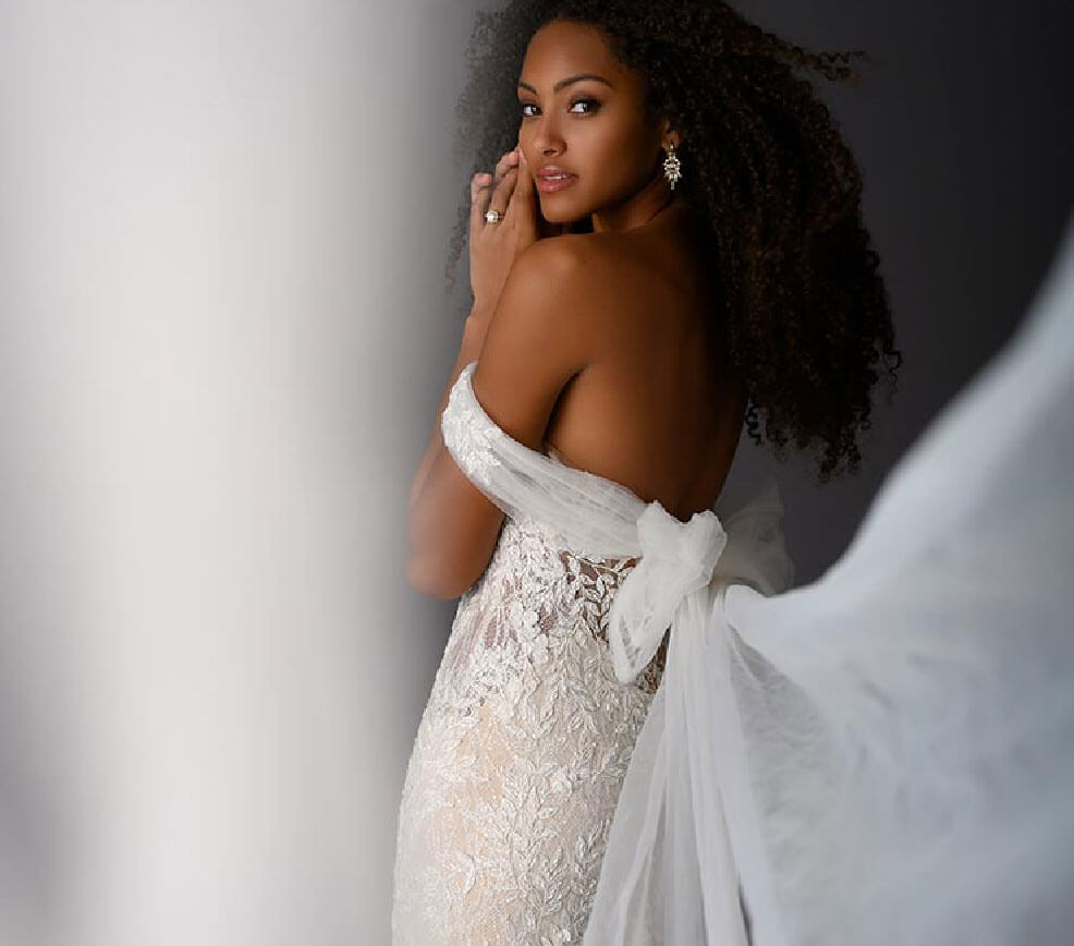 Model wearing a bridal Collection Gown by Brides by the Falls