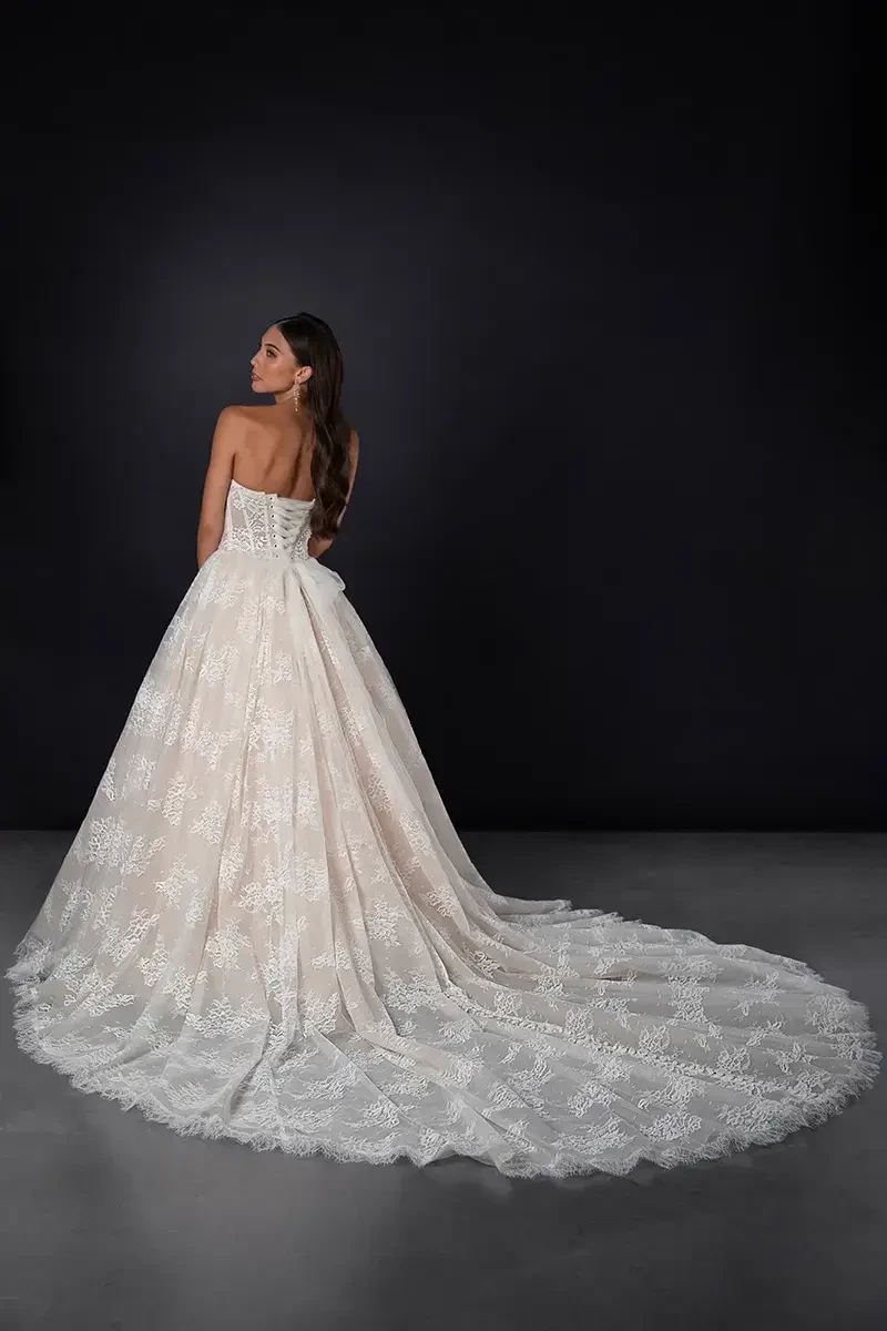 model is wearing a strapless basque waist wedding gown