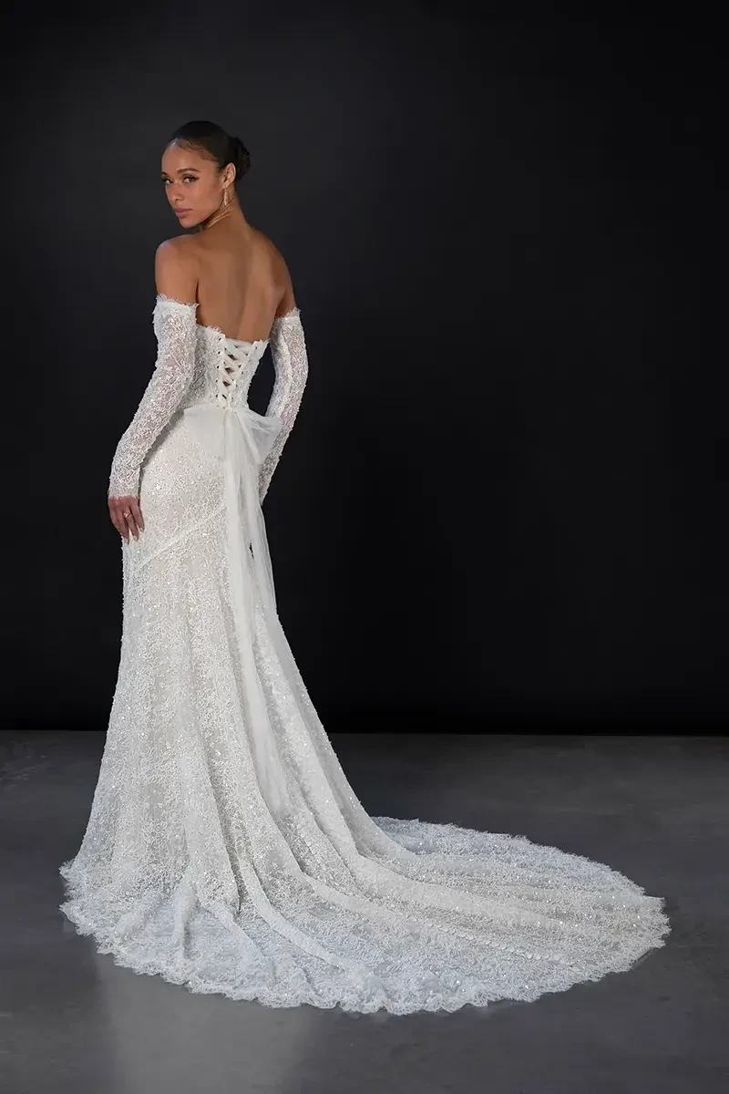 model is wearing an off the shoulder lace fit and flare gown