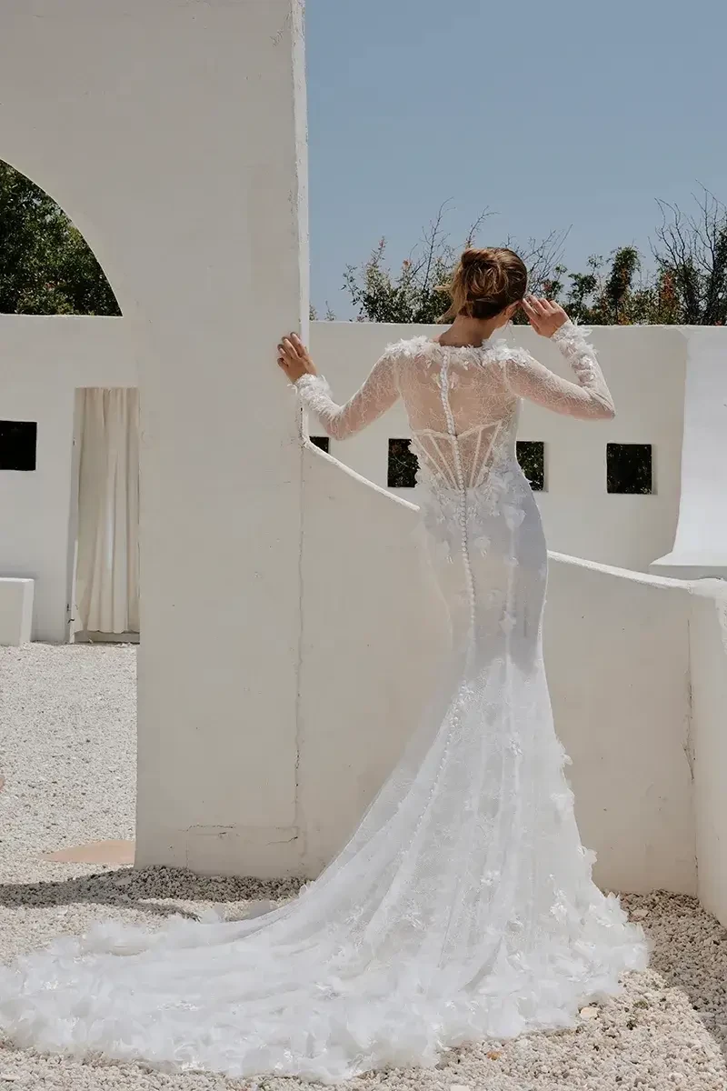 model is wearing an allover lace fit and flare bridal gown