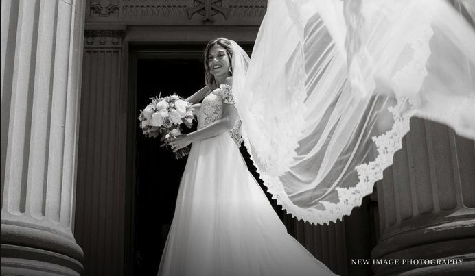 Model wearing a bridal Collection Gown by Brides by the Falls