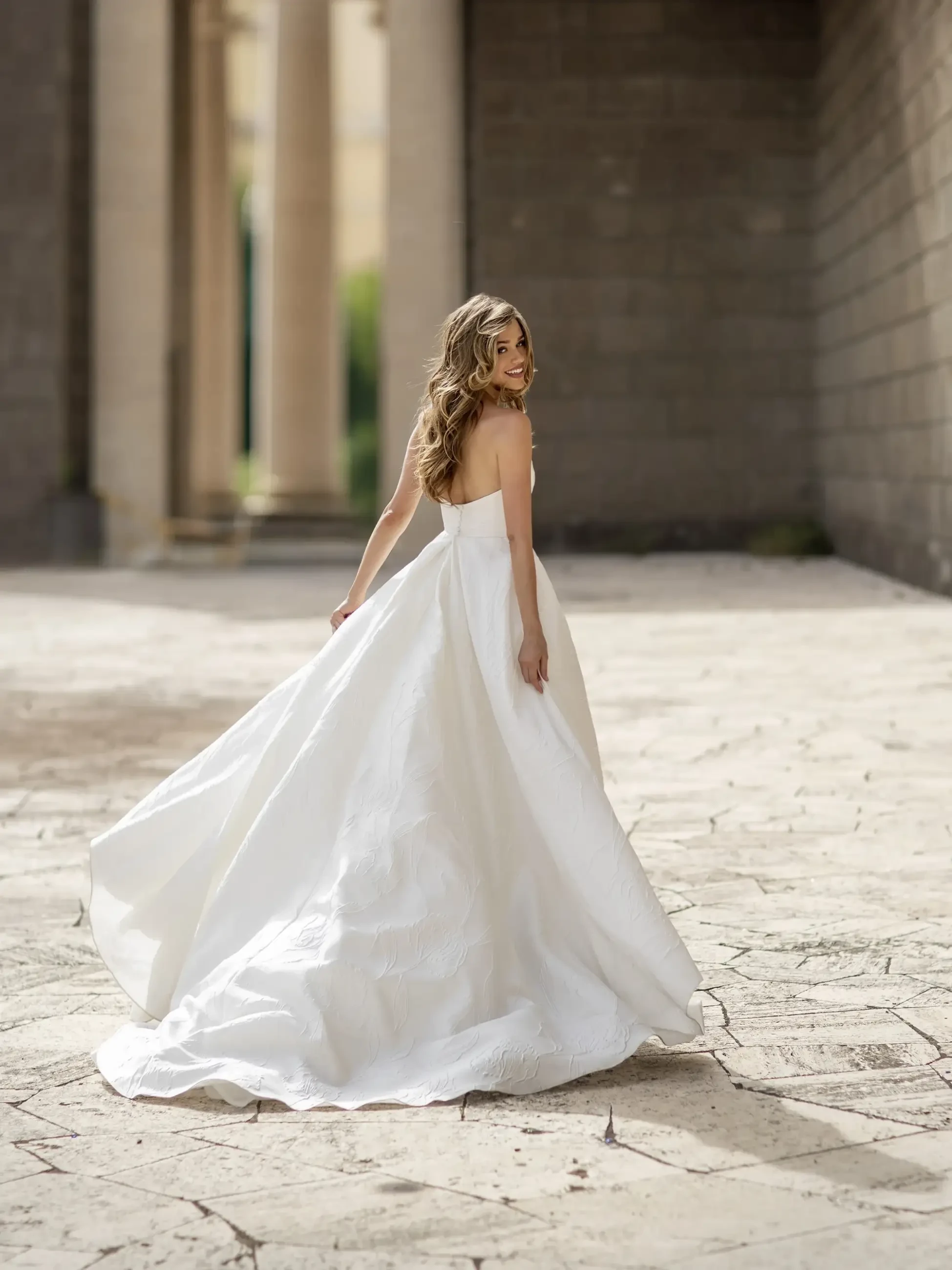 model is wearing a strapless a-line wedding dress