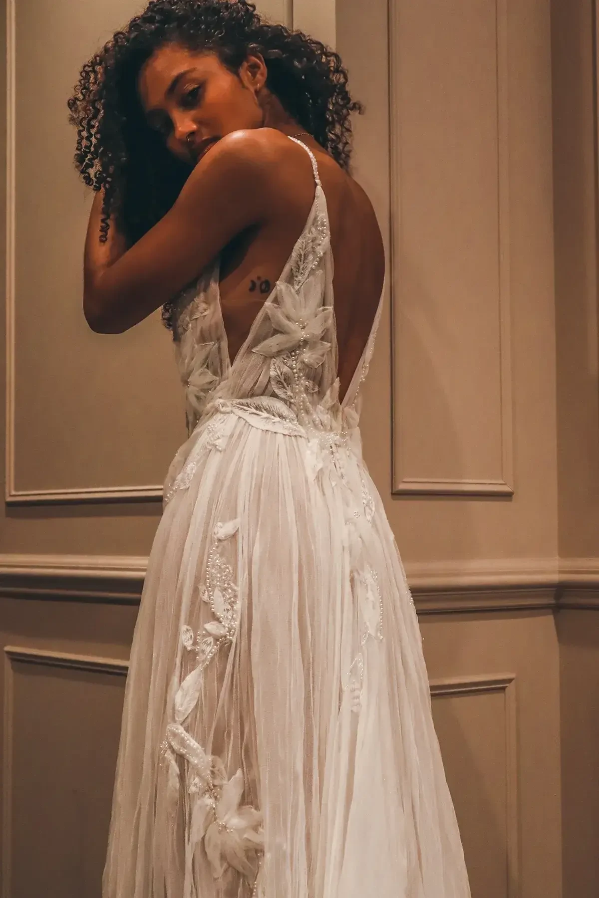 model is wearing a sleeveless a-line wedding gown