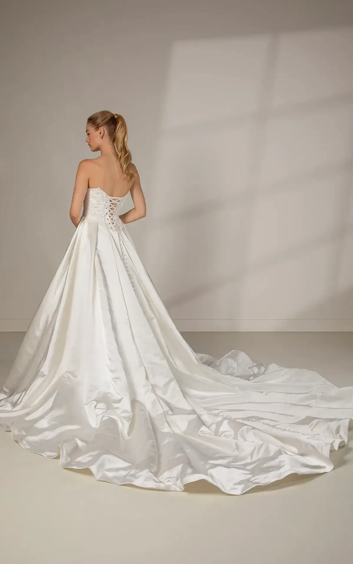 model is wearing a strapless basque waist ball gown