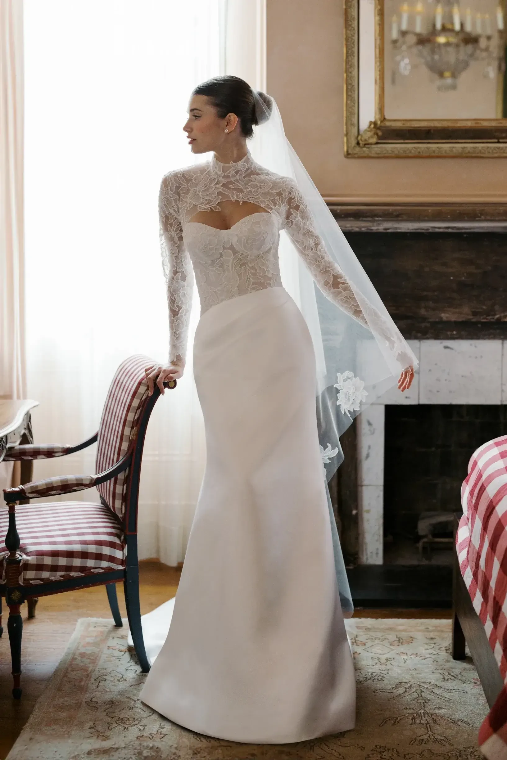 model is wearing a lace sweetheart neckline bridal gown