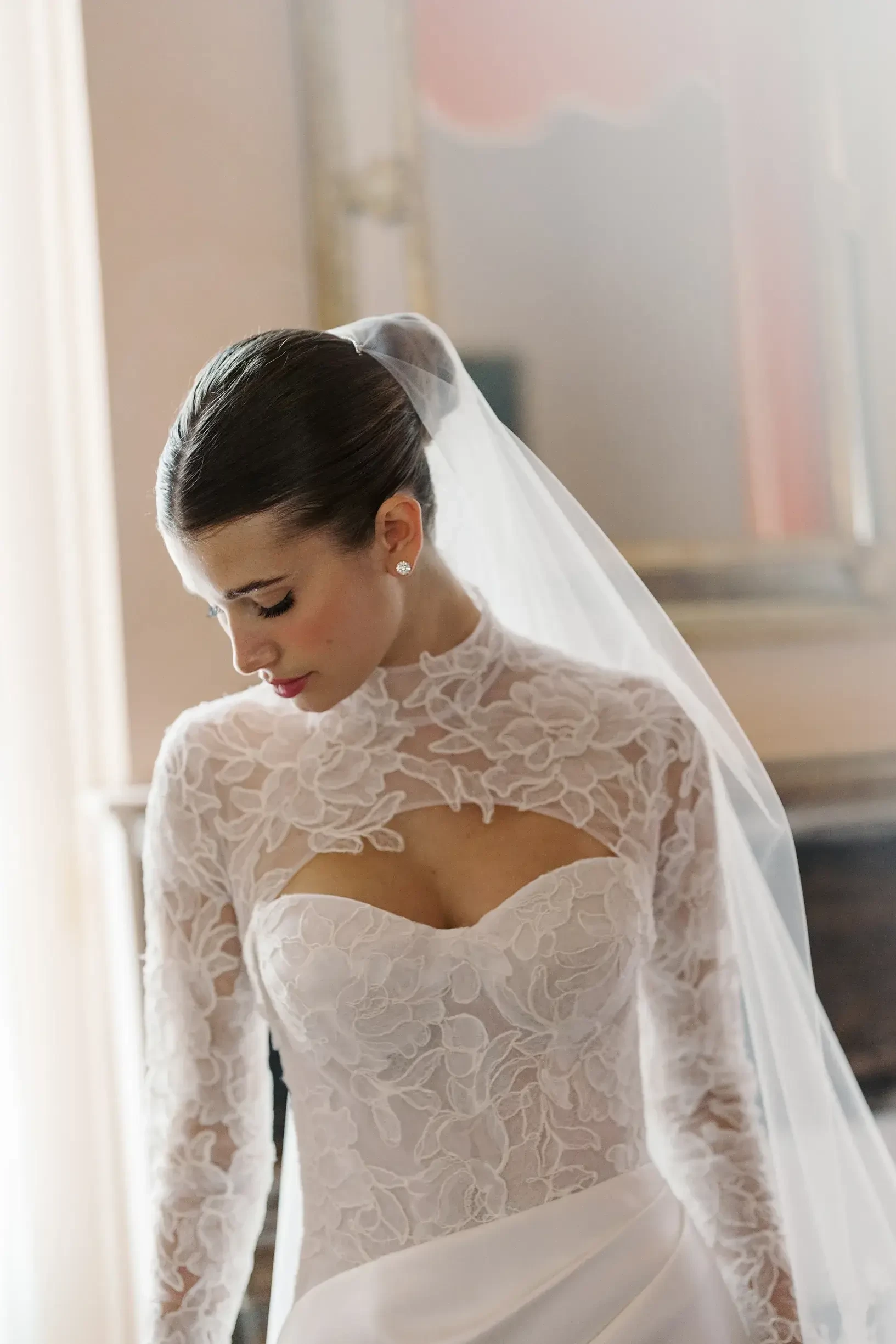 model is wearing a lace sweetheart neckline bridal gown